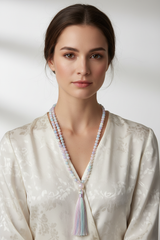 Elegant female model wearing Le Opaline Mala pastel gemstone mala necklace