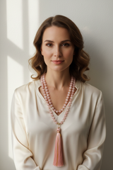 Elegant female model wearing Le Amara Mala blush gemstone mala necklace
