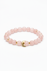 Luxury feminine spiritual bracelet with rose quartz beads and gold crescent moon charm, front view